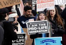 Prolife rally with people holding signs and banners