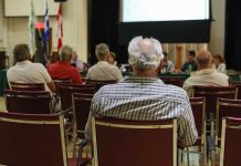 People attending a meeting in a conference room.